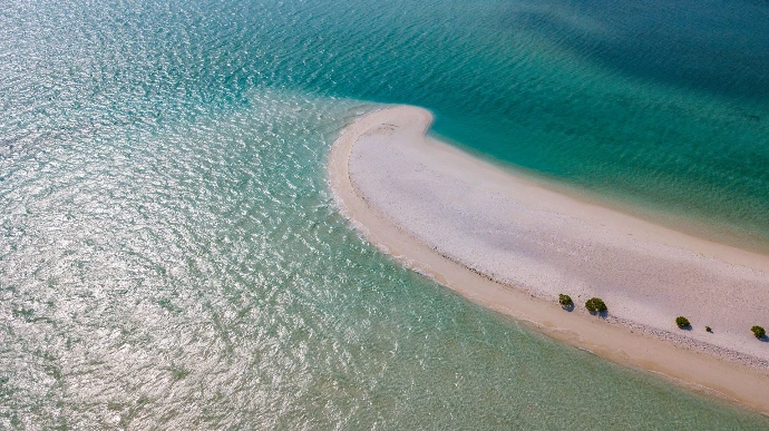 ue aérienne d'une plage d'île privée, sable blanc et eau claire